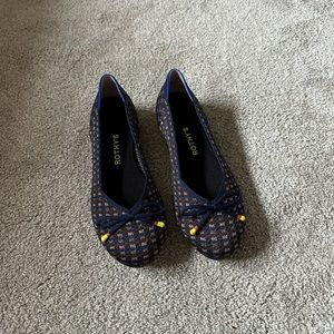 Navy and gold Rothy’s